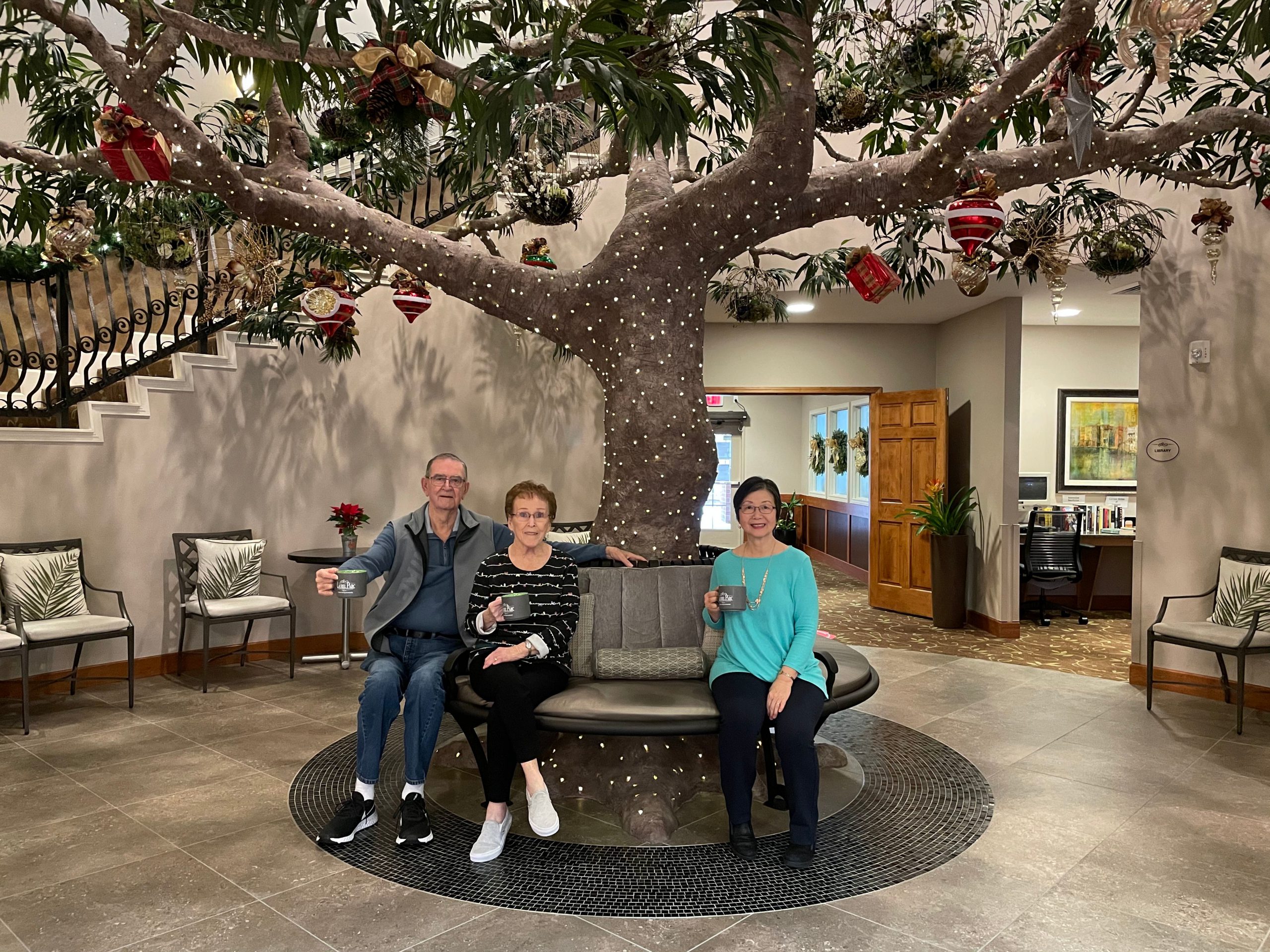assisted senior living portland 1, friends under lit tree in entry way of laurel parc